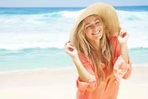 Women in hat on smiling on beach