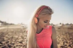 woman listening to music at beach